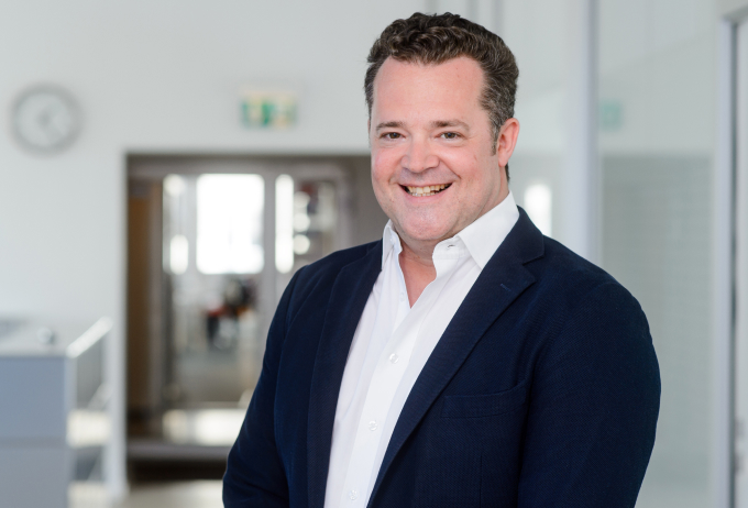 A man smiling in an office.