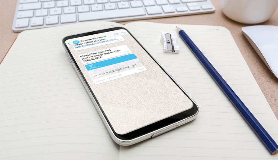 A smartphone with a text message on it sitting on a desk.