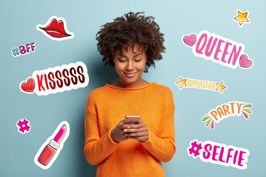 A young woman using a smartphone covered with stickers, while engaged in messaging conversations for various brands.