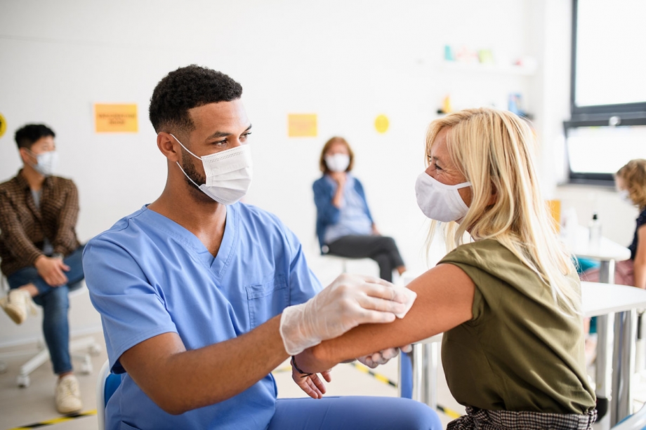 A nurse is administering a vaccine to a patient.